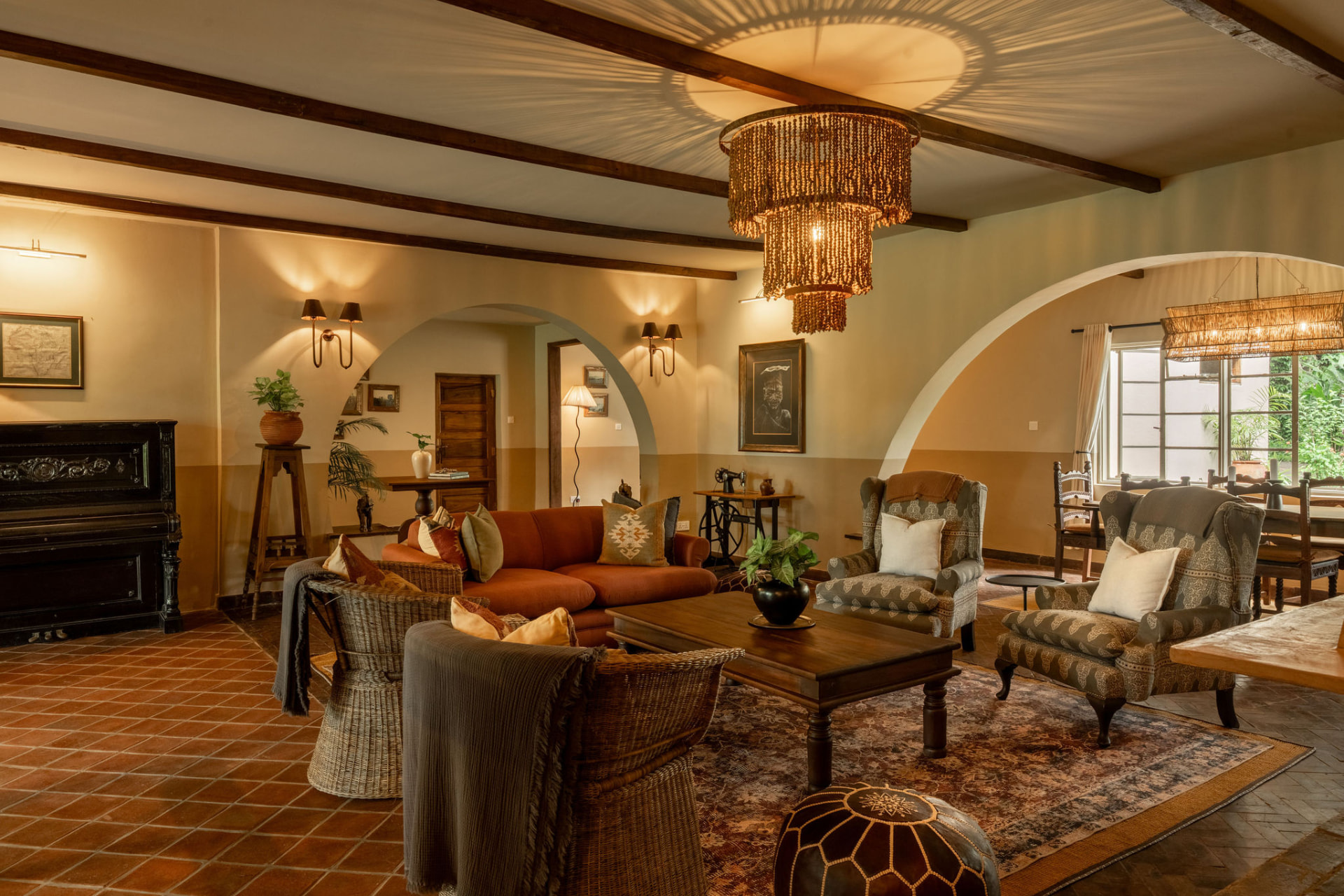 Closed: Mar 29–May 16, 2027. Rivertrees Country Inn sitting room, warmly furnished lounge with wooden beams and garden views near Arusha, Tanzania