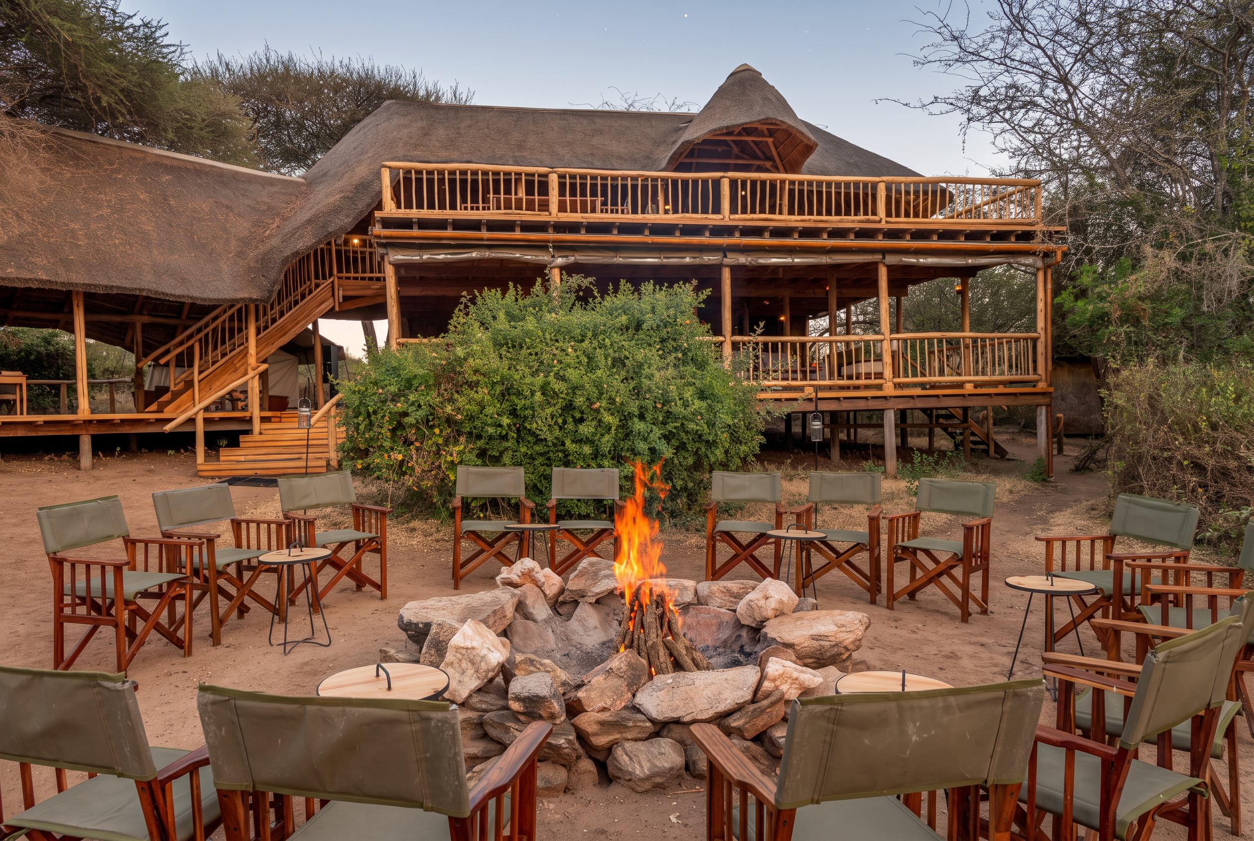 Closed: Apr 1–30. Oliver's Camp main lodge and campfire circle with canvas chairs in Tarangire National Park