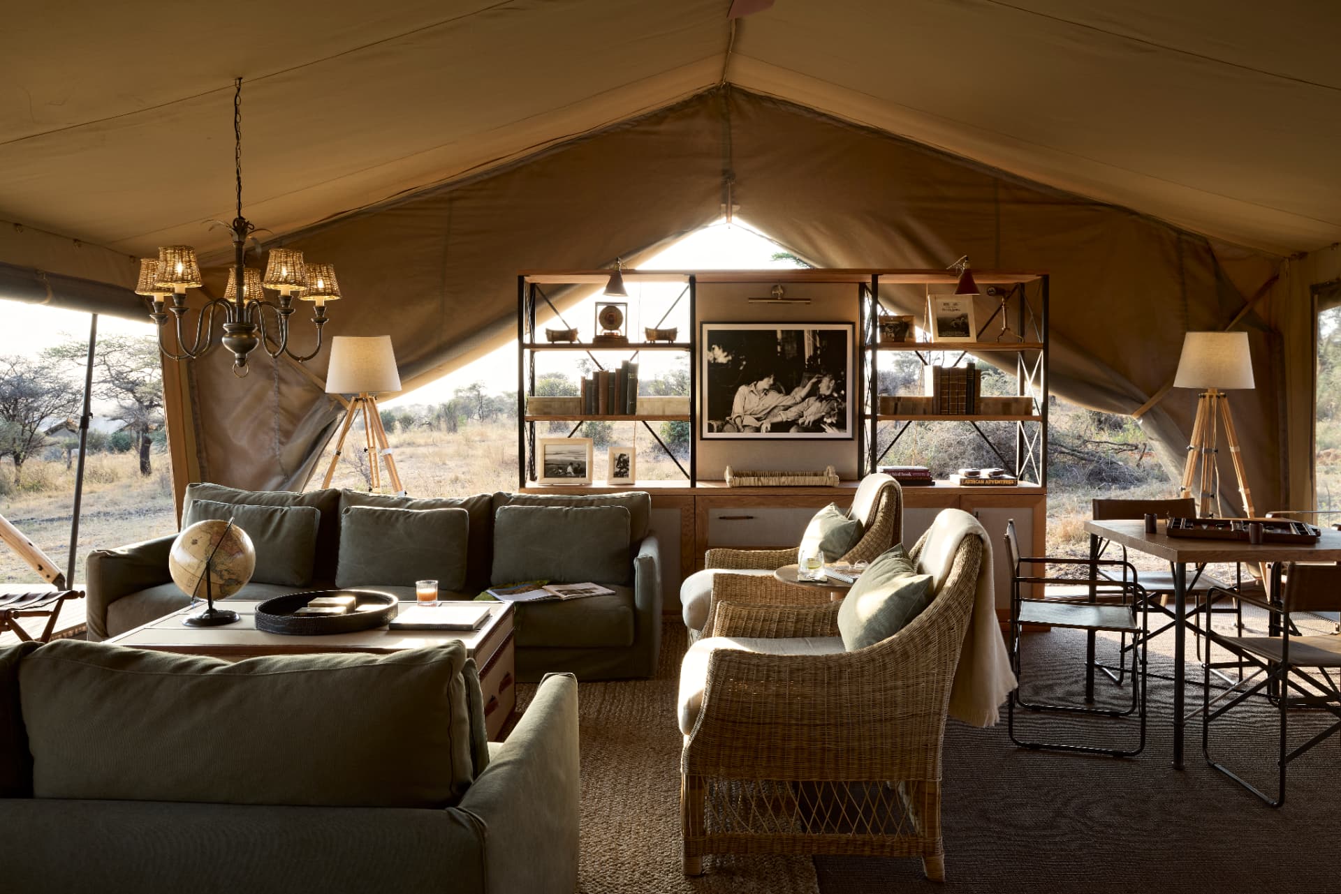 Closed: Mar 15–May 14. Out Of Africa Legend main lounge and bar tent, safari sofas, wicker chairs, bookshelves and canvas canopy open to the Serengeti